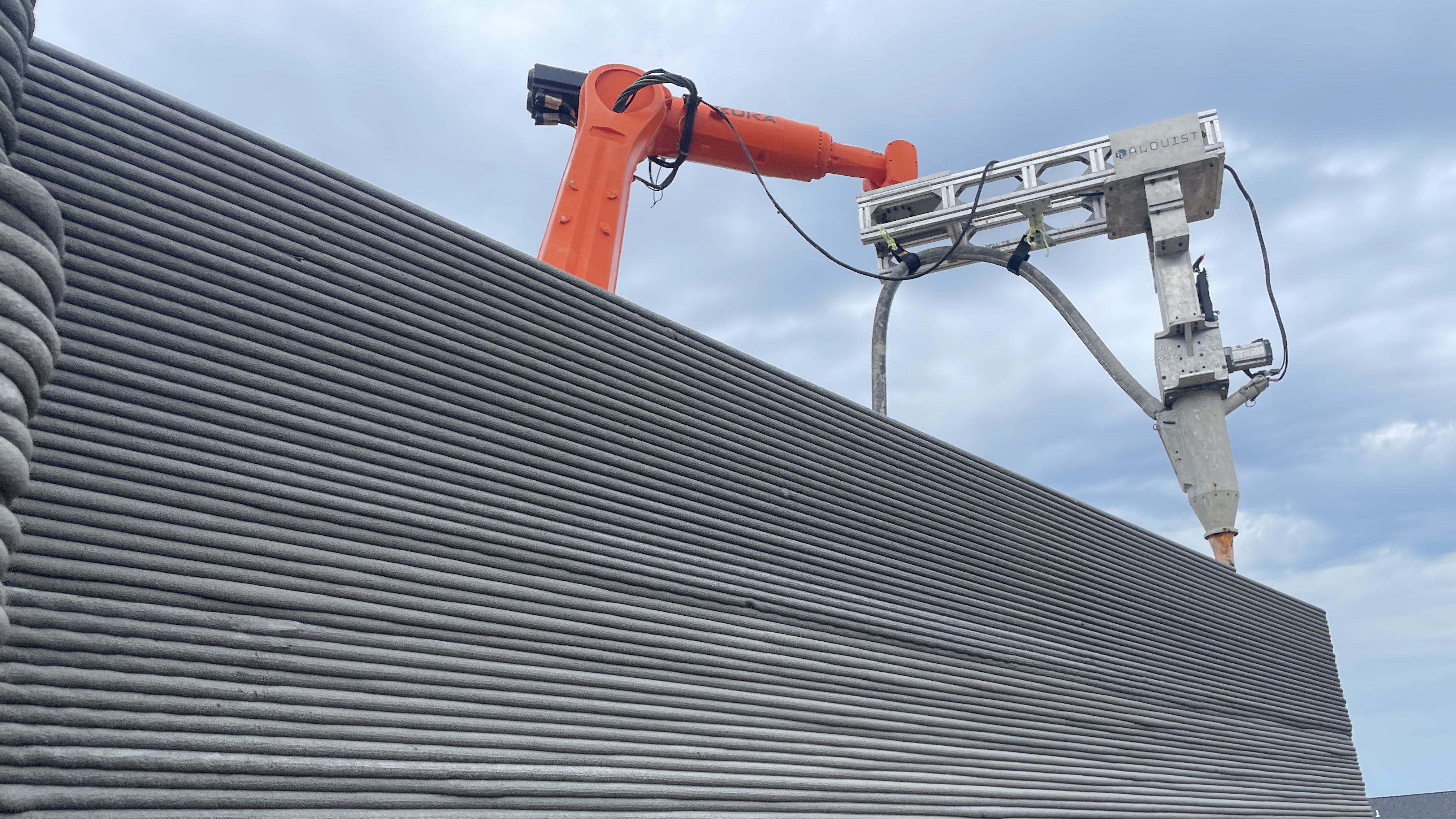 A robotic 3D printing arm is laying the walls of a fire-resistant ADU in Walnut, California. (RIC Technology)