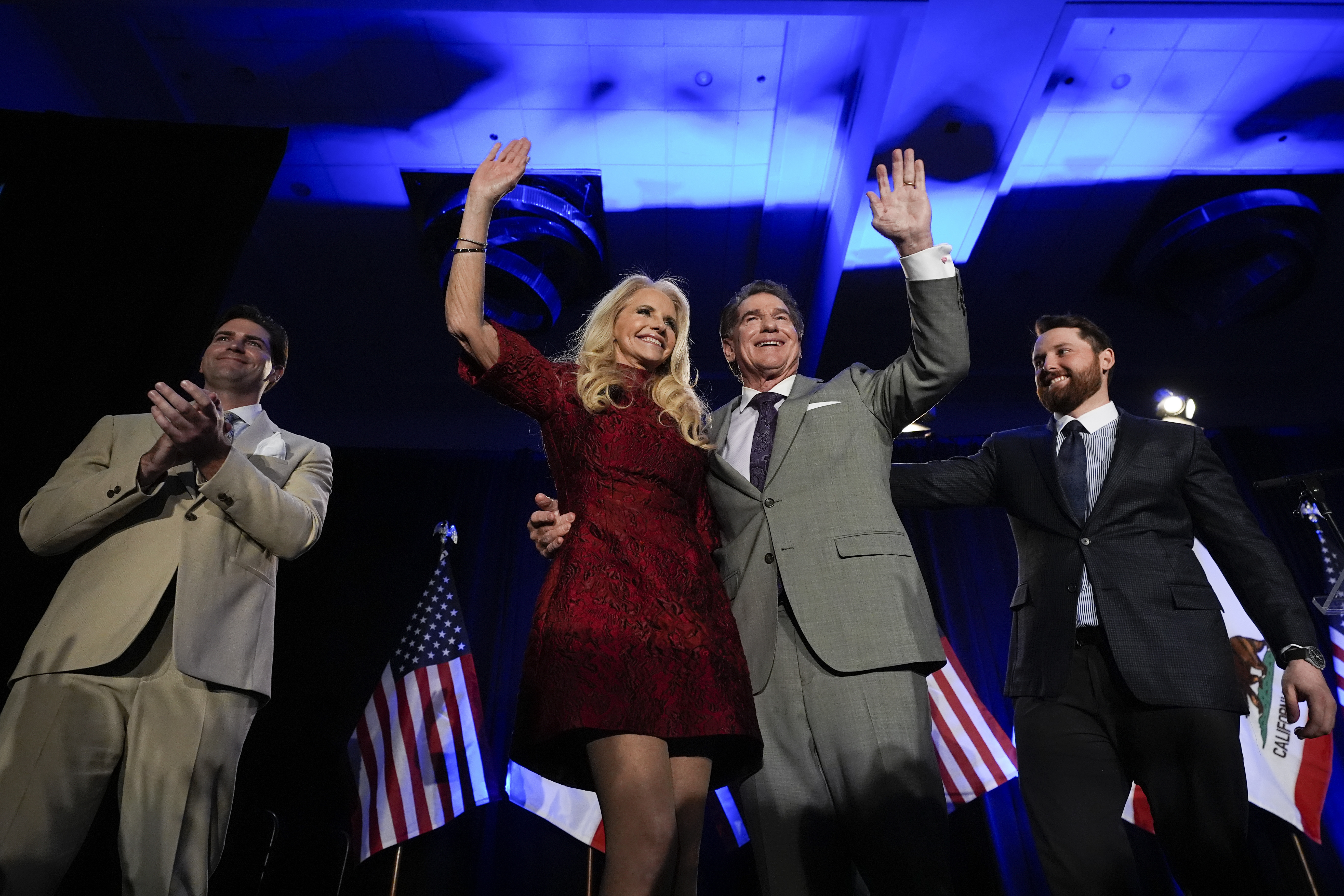 Republican U.S. Senate candidate Steve Garvey, center right, hugs his wife Candace standing next to his sons Ryan, left, and Sean during his election night party, Tuesday, March 5, 2024, in Palm Desert, Calif.
