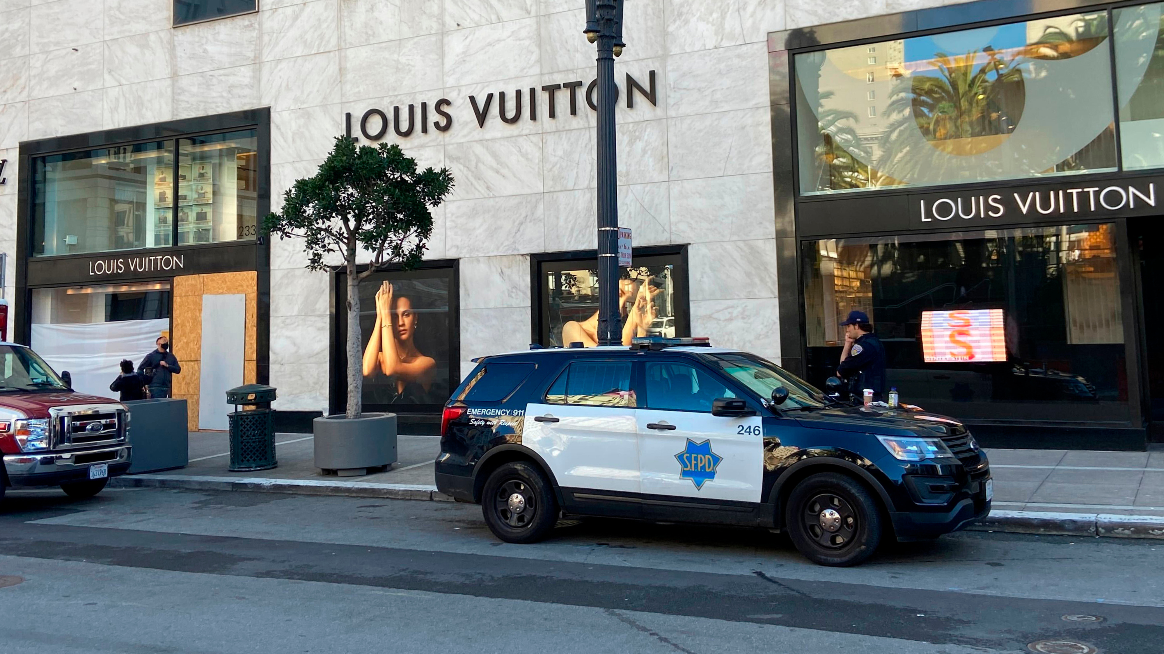 Police officers and emergency crews park outside the Louis Vuitton store in San Francisco's Union Square on Nov. 21, 2021, after looters ransacked businesses.