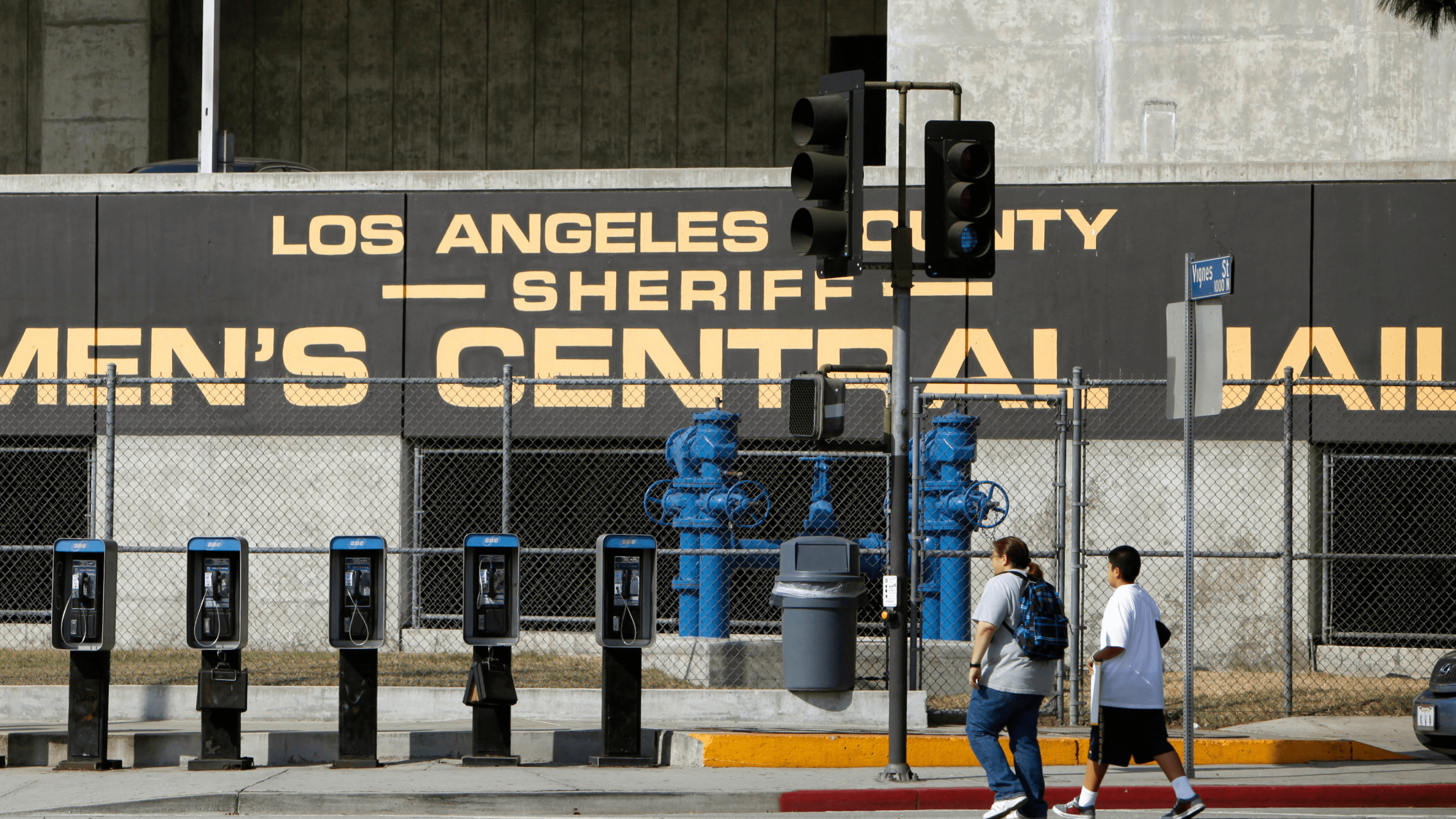 In this Sept. 28, 2011 photo, people walk past the Los Angeles County Sheriff's Men's Central Jail facility in Los Angeles.